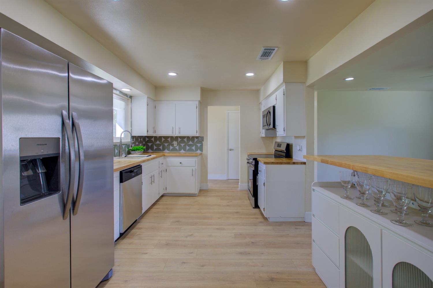 1673 Sacramento Drive Merced, CA 95348 - Photo 8 of 35 a kitchen with refrigerator and microwave