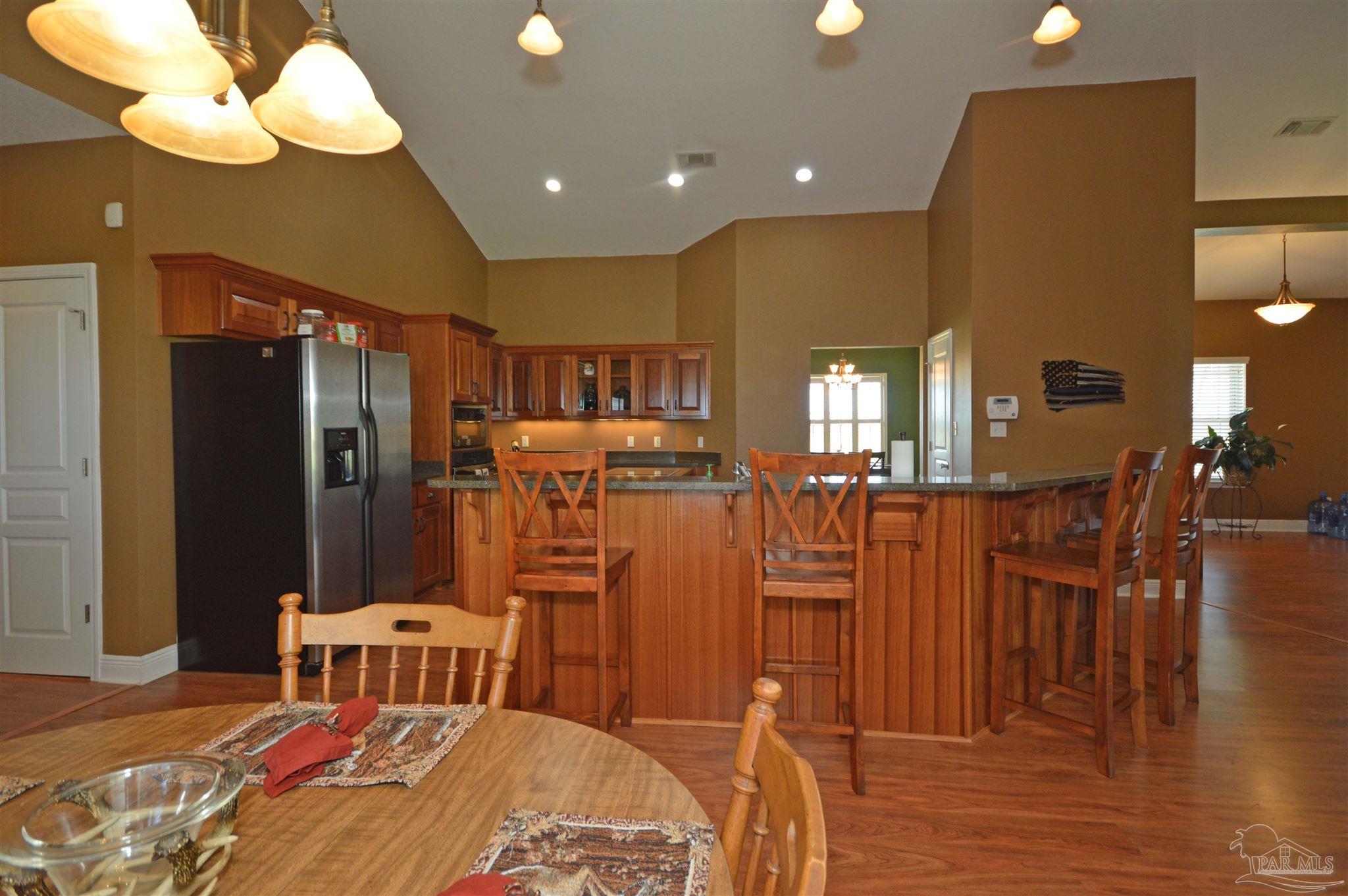 3478 Pine Level Church Road Jay, FL 32565 - Photo 21 of 50 a bedroom with a bed and a chandelier