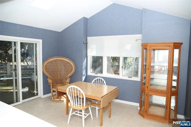 a dining room with furniture and a window