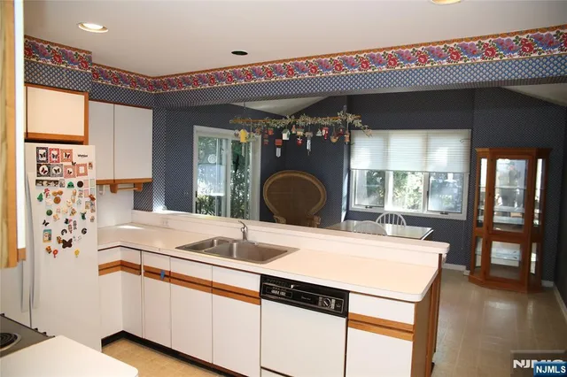 a kitchen with a sink and a large window