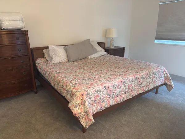 a bed sitting in a bedroom next to a window