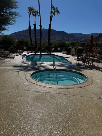 a view of swimming pool with a table and chairs