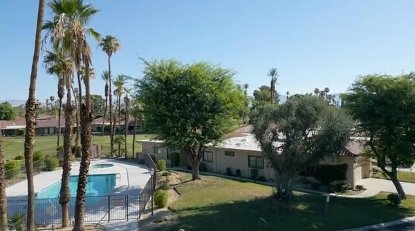 a view of swimming pool with a table and chairs