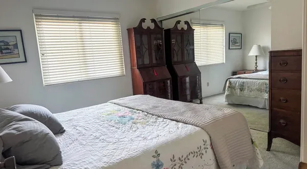 a bedroom with a bed window and a closet