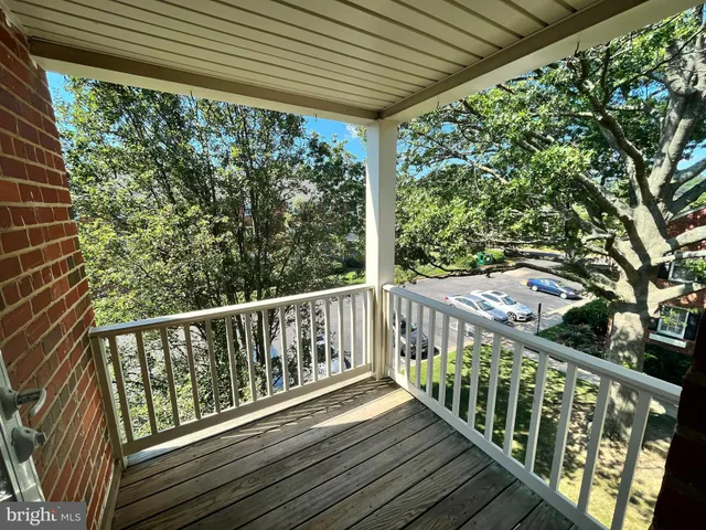 a view of balcony with wooden floor and fence