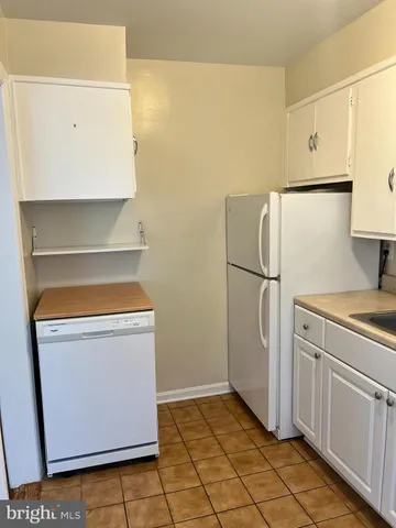 a kitchen with a refrigerator and a stove