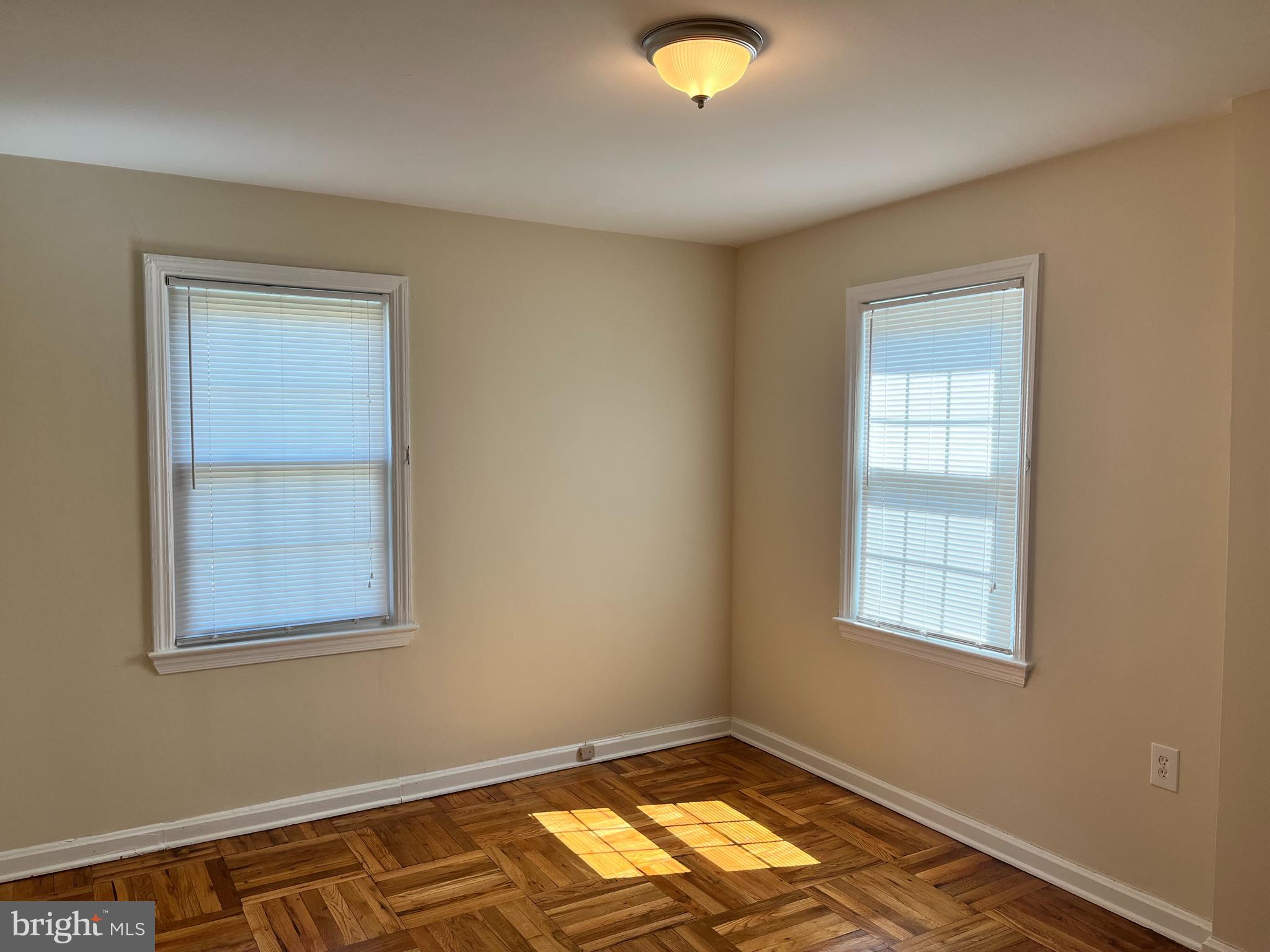 6510 Potomac Avenue, Unit C2 Alexandria, VA 22307 - Photo 8 of 15 a view of an empty room with window and wooden floor