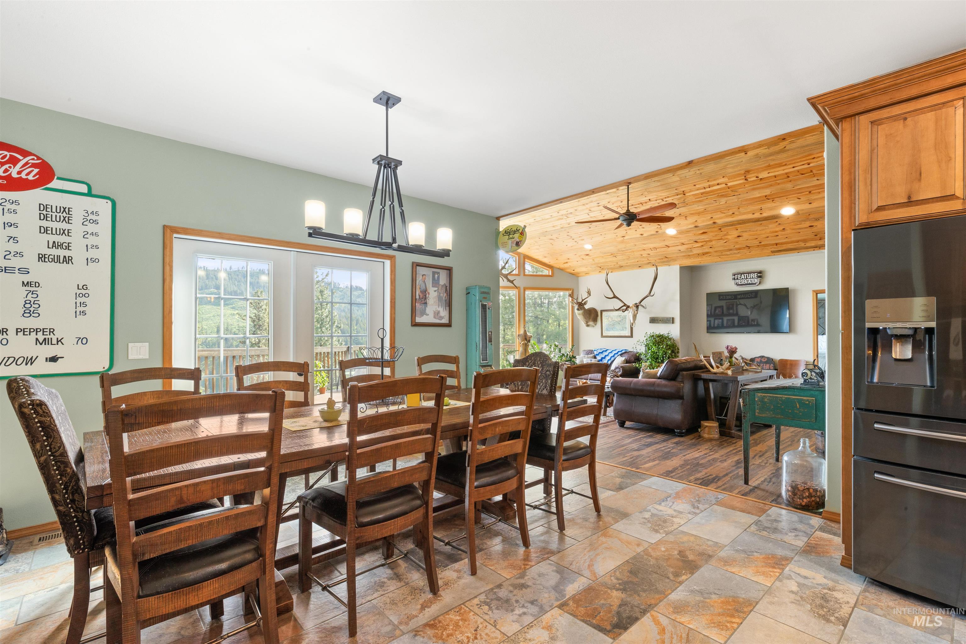 643 Adams Road Orofino, ID 83544 - Photo 15 of 50 Dining space featuring vaulted ceiling, hanging lights, ceiling fan, and light stone finish flooring