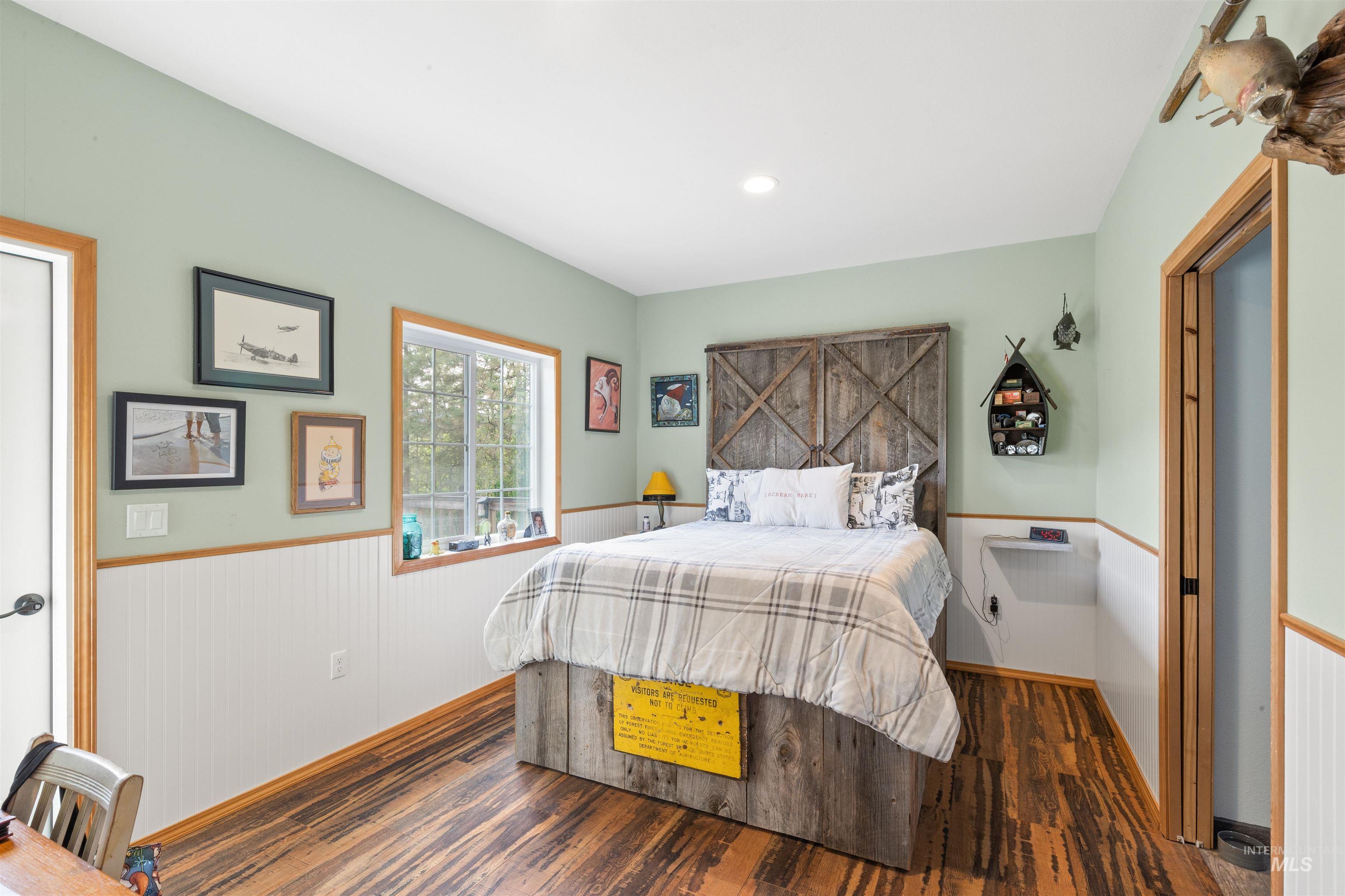 643 Adams Road Orofino, ID 83544 - Photo 17 of 50 Bedroom featuring a wainscoted wall, wood finished floors, and recessed lighting
