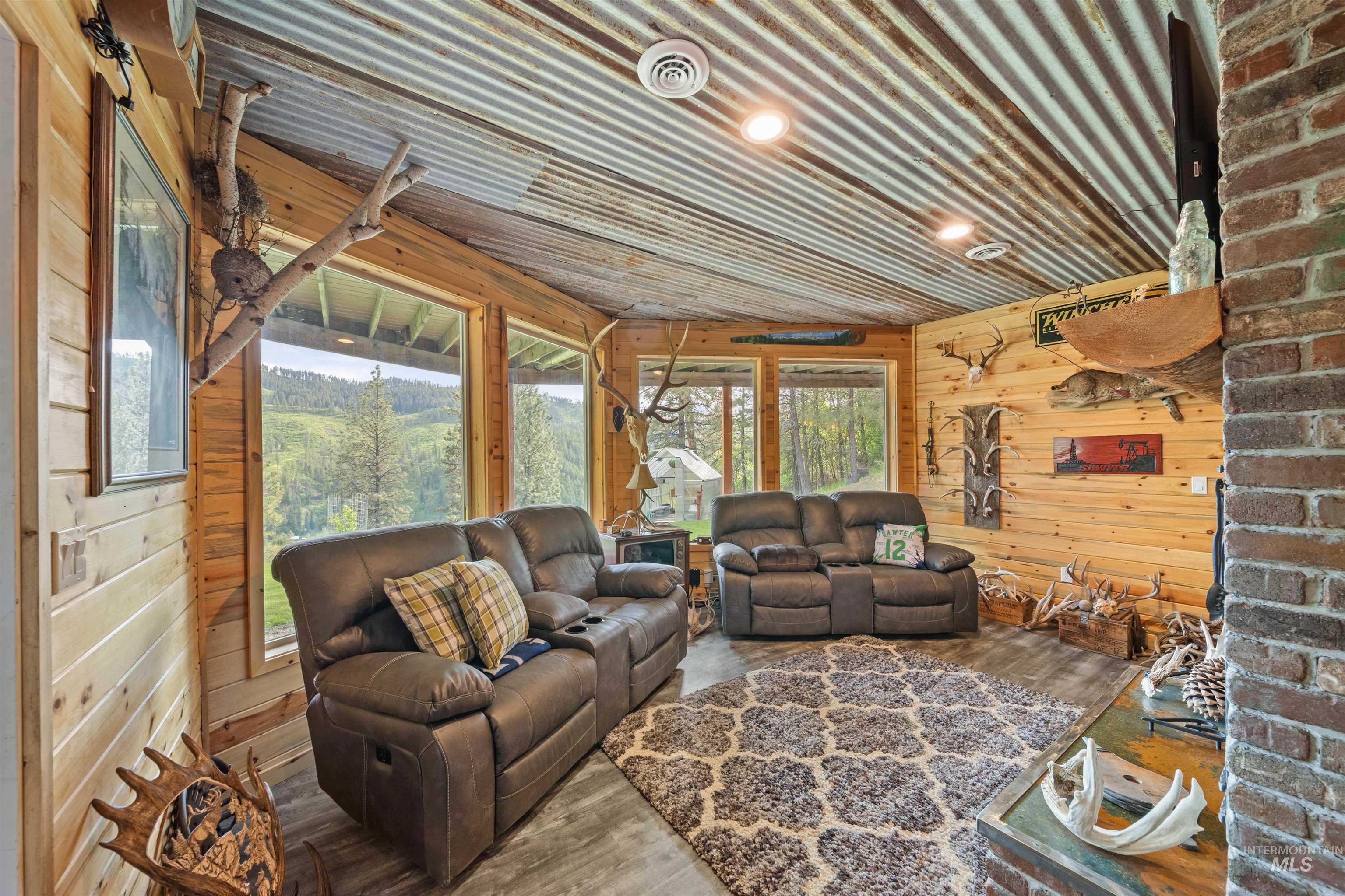 643 Adams Road Orofino, ID 83544 - Photo 28 of 50 Living area featuring wooden walls and wood finished floors