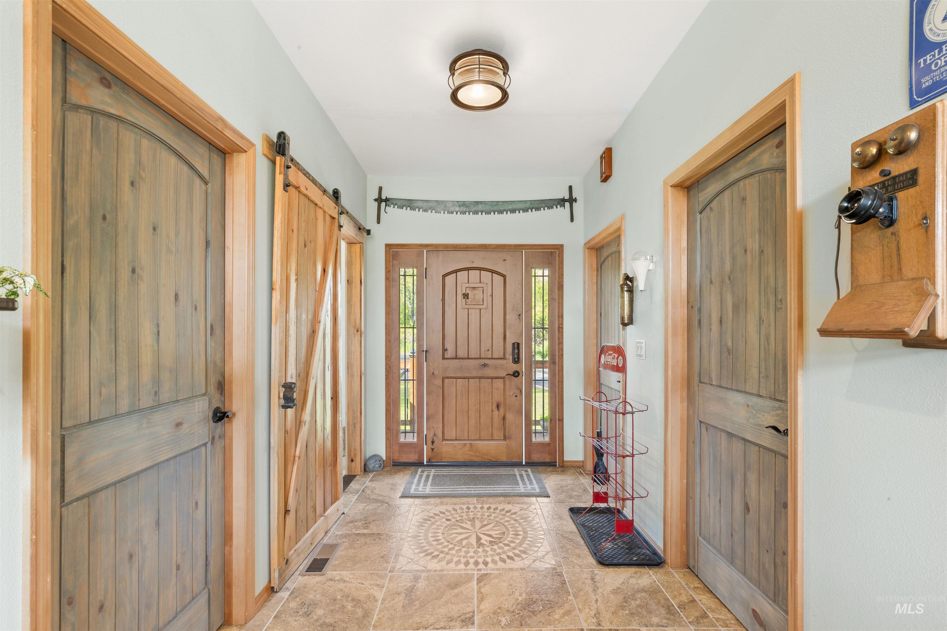 643 Adams Road Orofino, ID 83544 - Photo 8 of 50 Foyer with a barn door and stone finish flooring