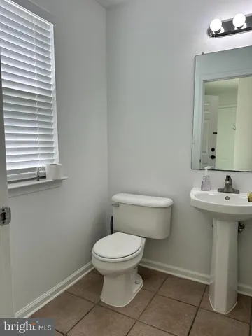 a white toilet sitting next to a bathroom sink