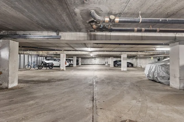 a view of parking garage with cars