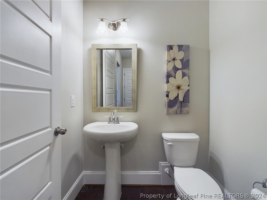 4001 Banks Stone Drive Raleigh, NC 27603 - Photo 18 of 50 a bathroom with a toilet sink and mirror