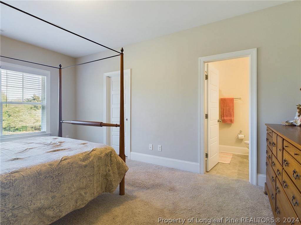 4001 Banks Stone Drive Raleigh, NC 27603 - Photo 34 of 50 a bedroom with a bed and wooden floor