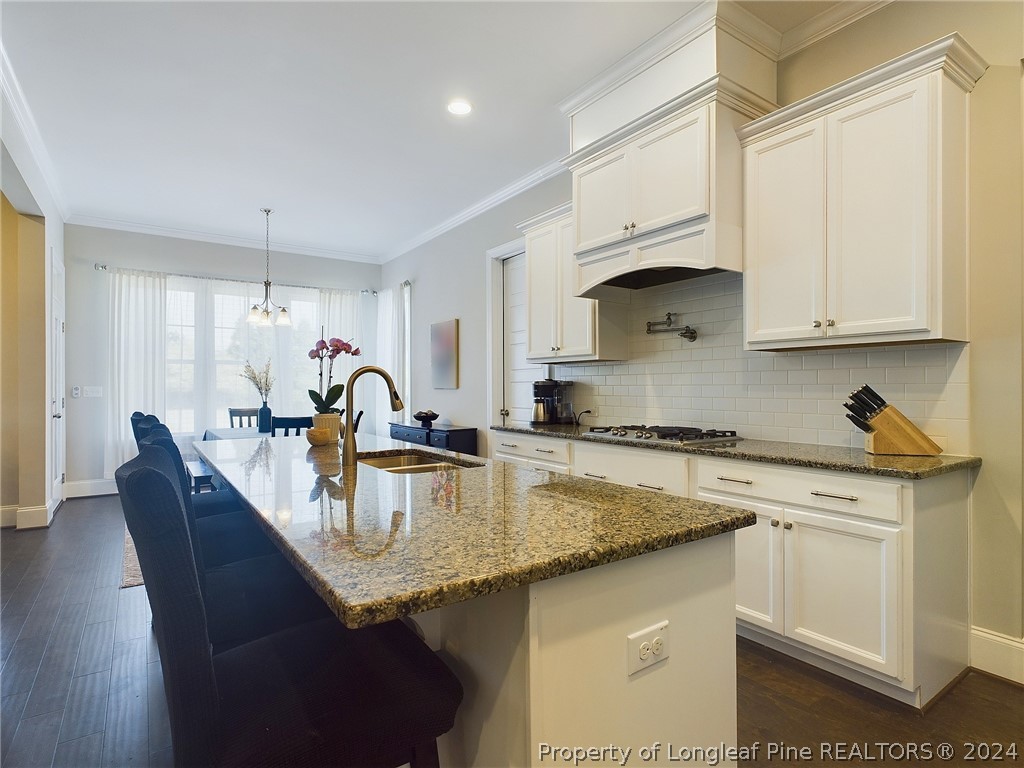 4001 Banks Stone Drive Raleigh, NC 27603 - Photo 9 of 50 a kitchen with granite countertop a sink a stove and cabinets