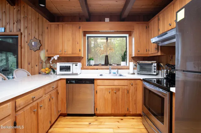 a bathroom with a sink a toilet and shower curtain
