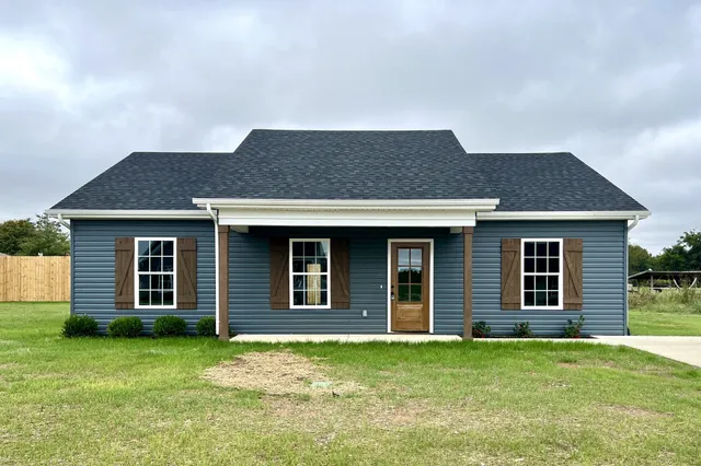 a front view of a house with a garden