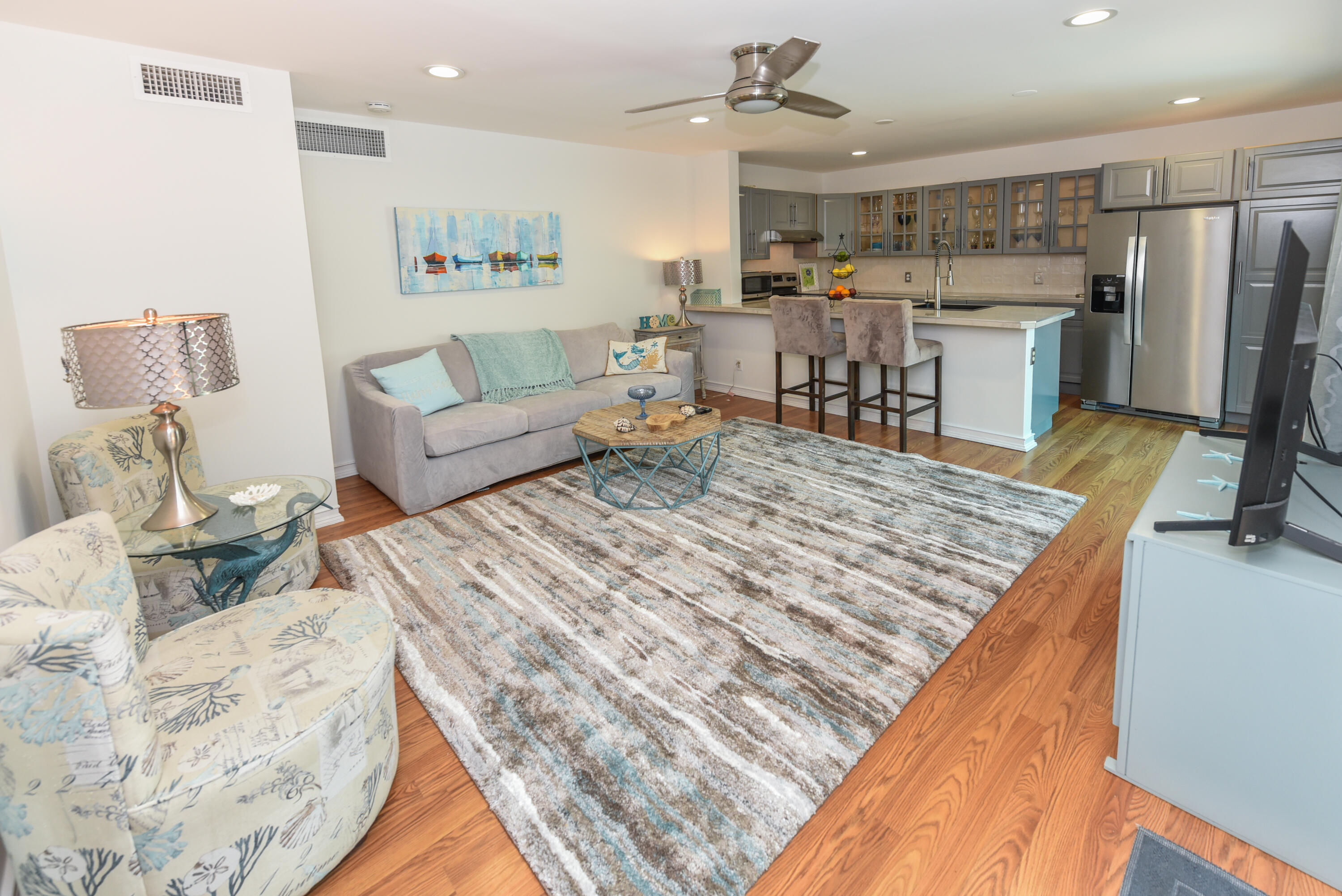 1605 Highway 1, Unit 1D Jupiter, FL 33477 - Photo 11 of 54 a living room with a couch and kitchen view