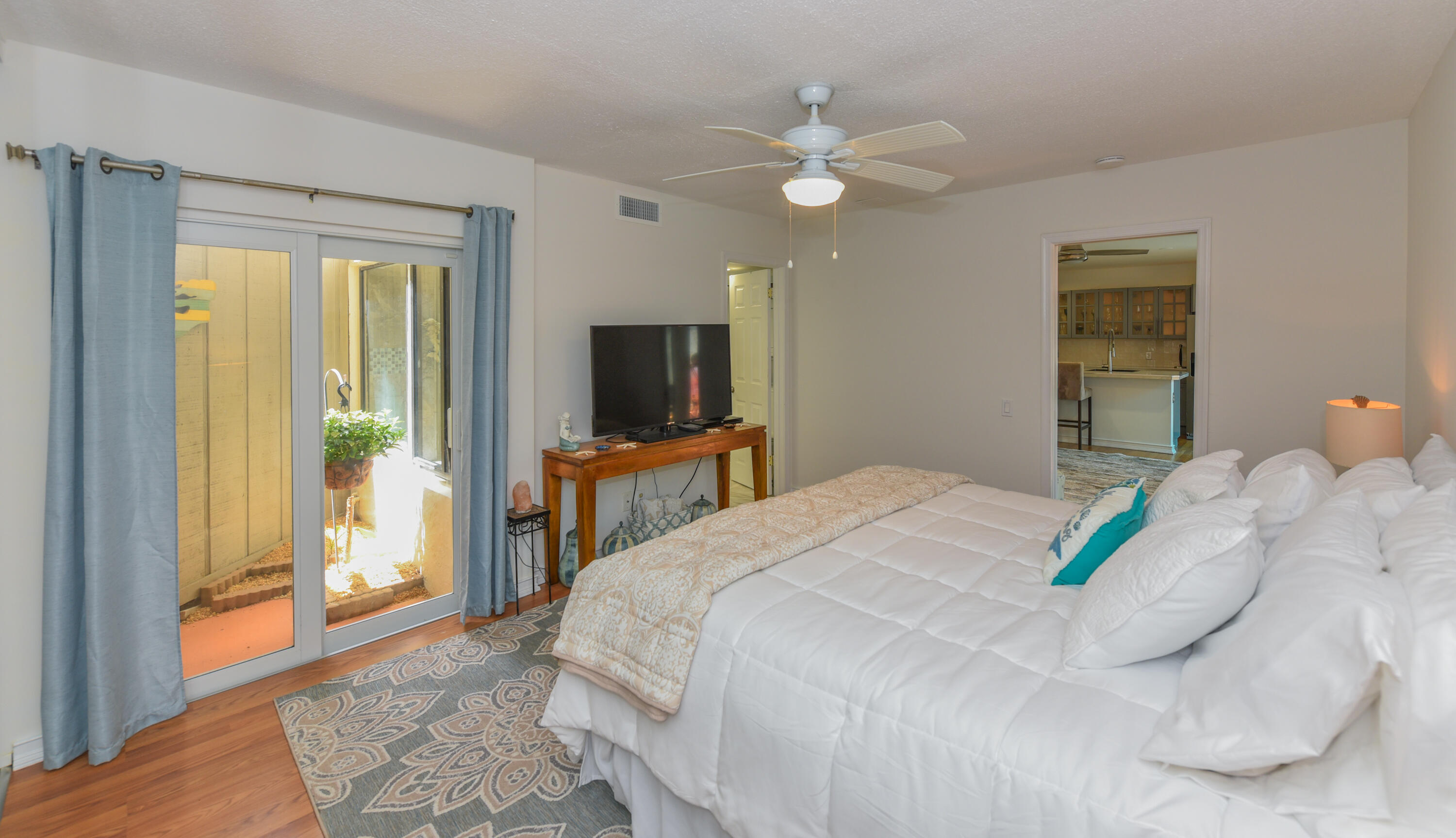 1605 Highway 1, Unit 1D Jupiter, FL 33477 - Photo 21 of 54 a bedroom with a bed and a chandelier
