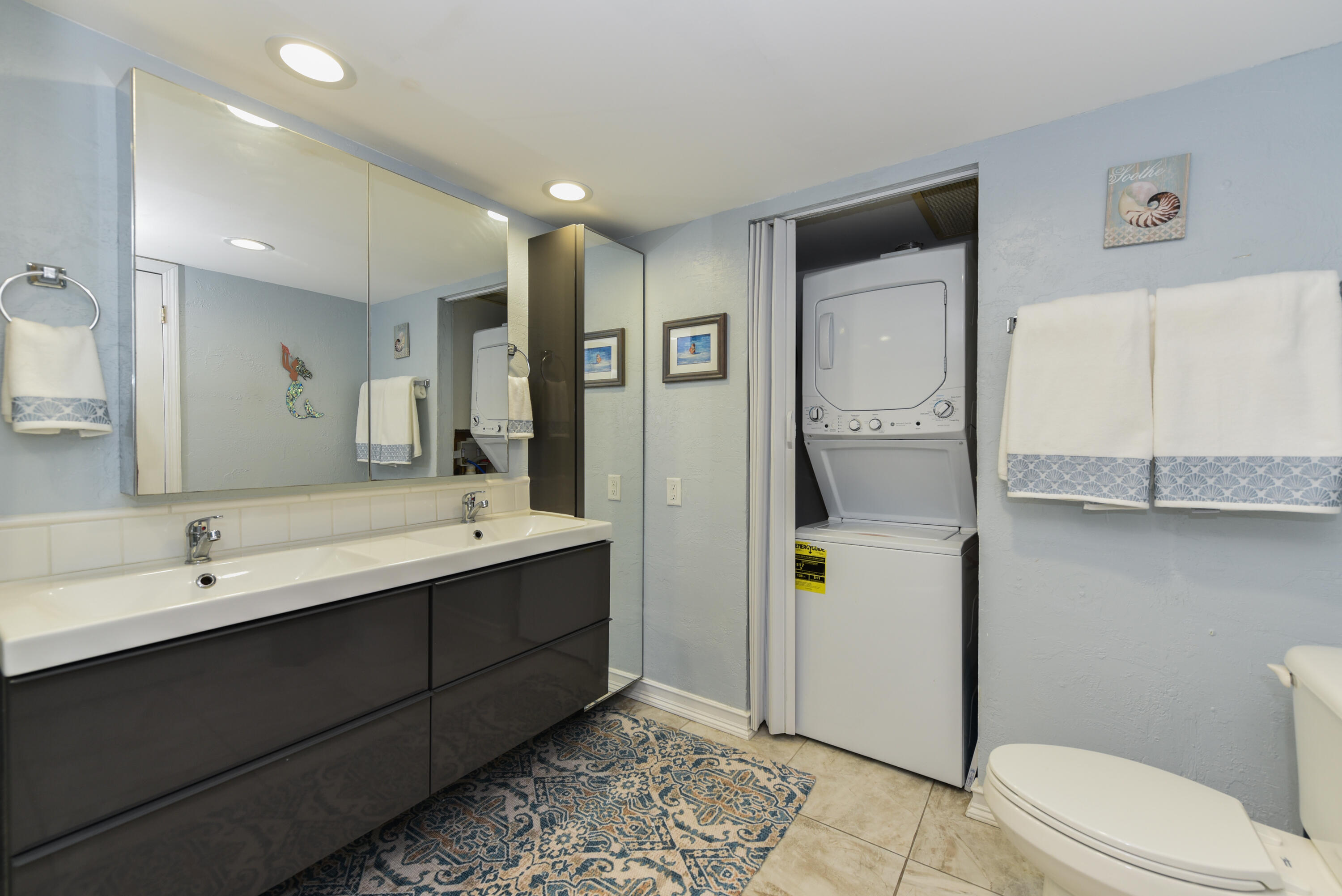 1605 Highway 1, Unit 1D Jupiter, FL 33477 - Photo 23 of 54 a bathroom with a double vanity sink toilet and shower