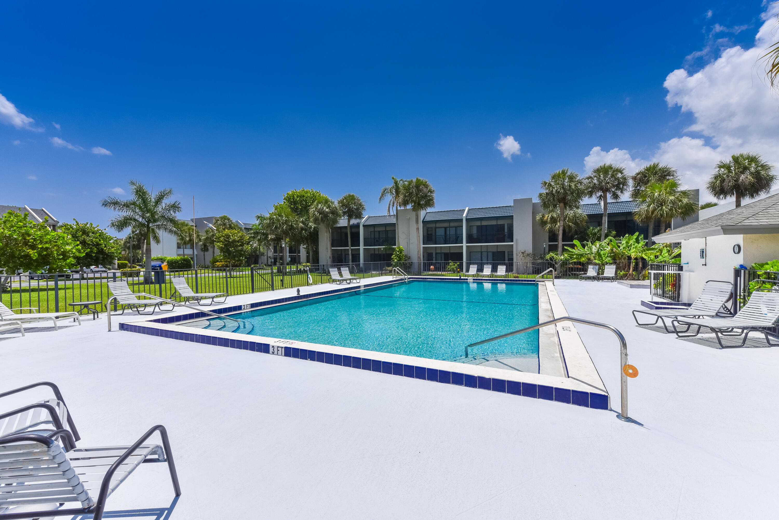 1605 Highway 1, Unit 1D Jupiter, FL 33477 - Photo 39 of 54 a view of a swimming pool with a patio and a yard with plants