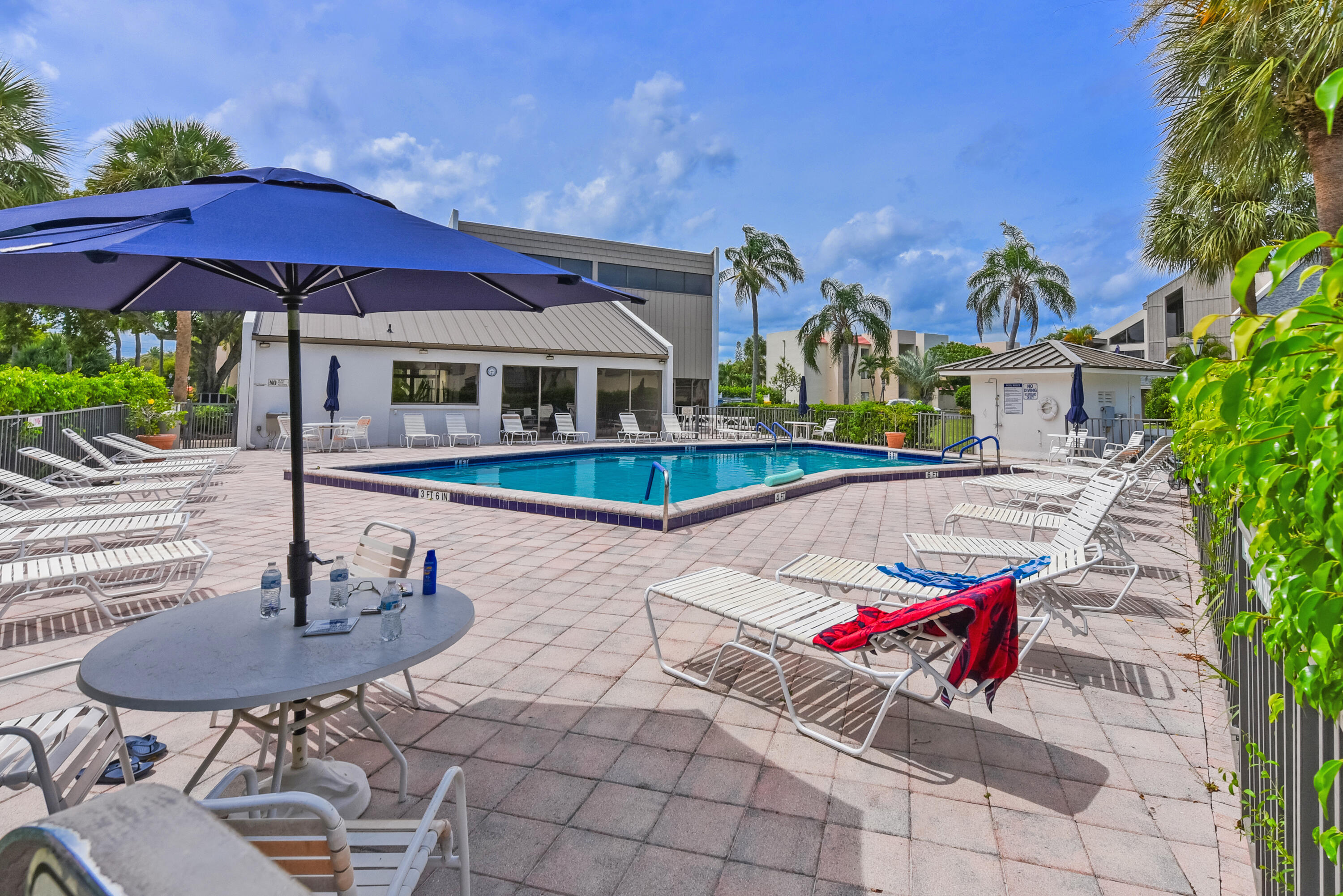 1605 Highway 1, Unit 1D Jupiter, FL 33477 - Photo 40 of 54 a view of a house with swimming pool and sitting area