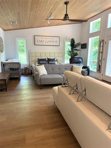 a spacious bedroom with a bed couch and a window