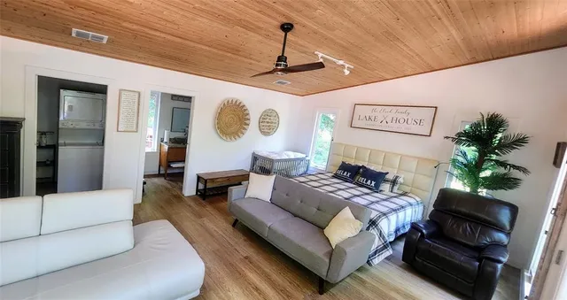 a spacious bedroom with a bed and a large window