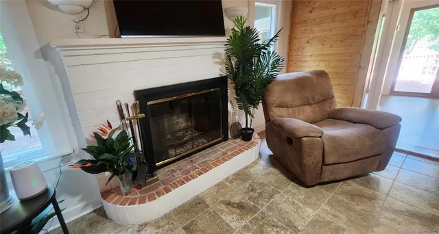 a kitchen with refrigerator and chairs