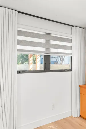 a spacious bedroom with a bed and a window