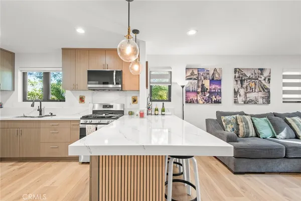 a view of a kitchen center island and stainless steel appliances