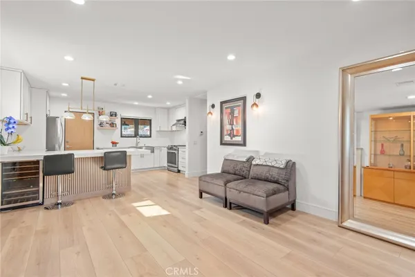 a living room with furniture and kitchen view