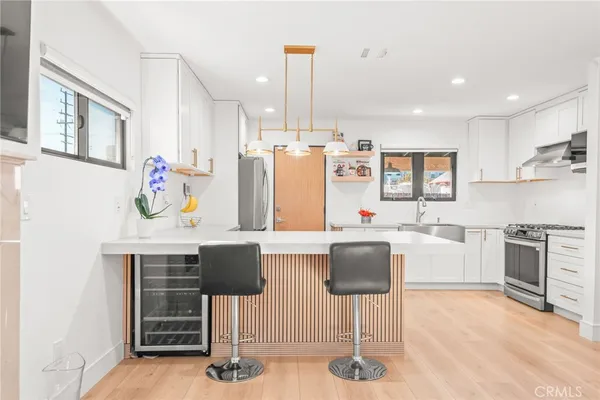 a kitchen with cabinets and chairs