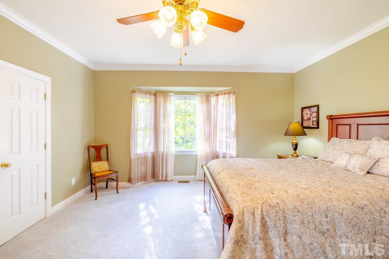 3197 A Walters Road Creedmoor, NC 27522 - Photo 33 of 50 a bedroom with a bed and a chandelier