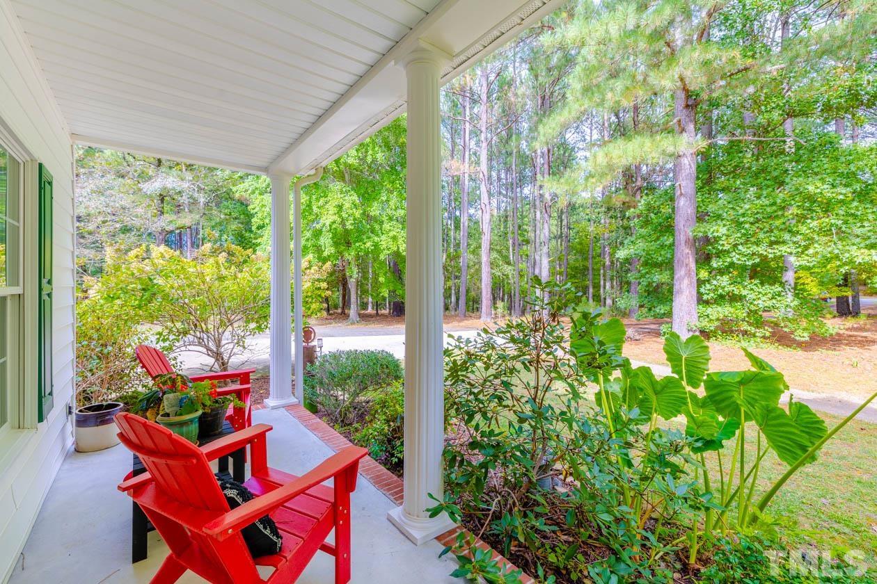 3197 A Walters Road Creedmoor, NC 27522 - Photo 5 of 50 a view of a chairs and table in a garden