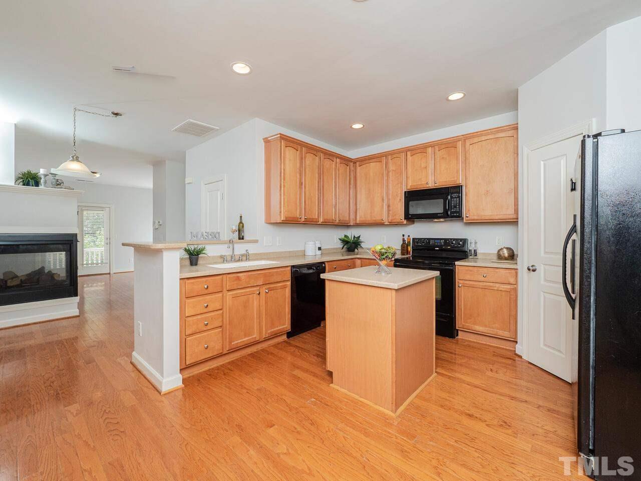 8007 Sycamore Hill Lane Raleigh, NC 27612 - Photo 9 of 22 Open kitchen with lots of cabinets and an island!