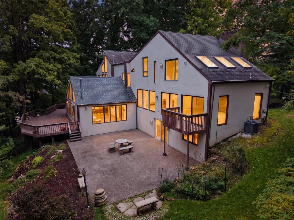 Contemporary architecture surrounded by more than two wooded acres.