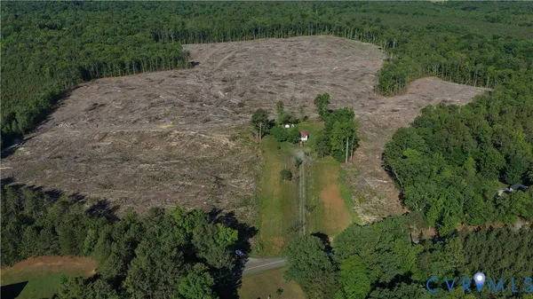 an aerial view of a houses with yard