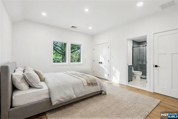 a bedroom with a bed and a couch