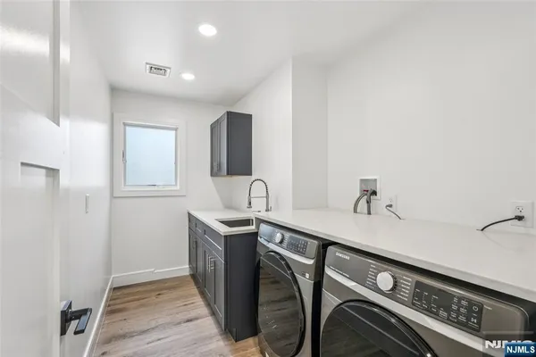 a kitchen with stainless steel appliances granite countertop a sink and cabinets