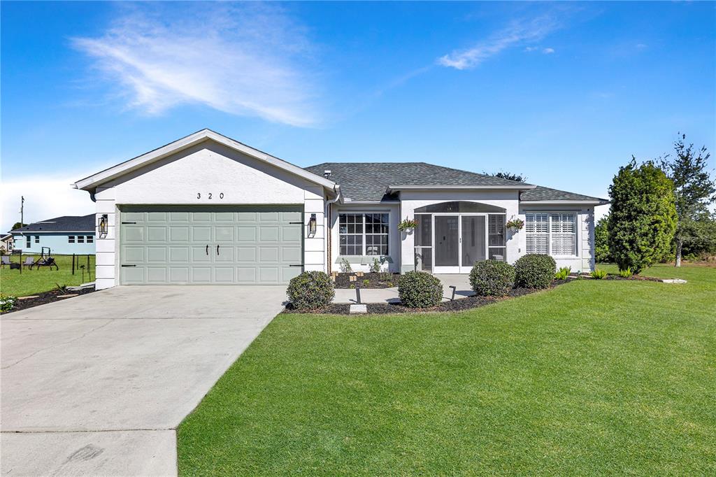 a front view of a house with a yard and porch