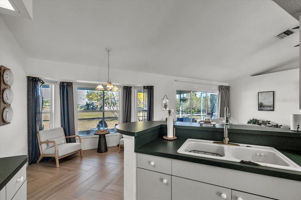 320 Tandil Street Punta Gorda, FL 33983 - Photo 22 of 67 a kitchen with kitchen island granite countertop a sink and a large window