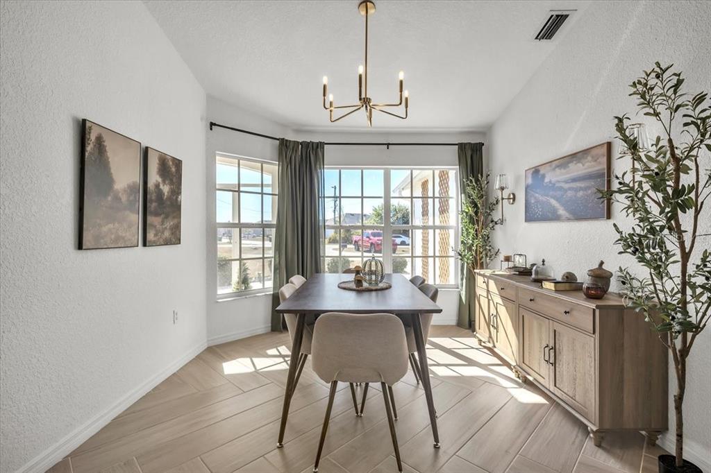 320 Tandil Street Punta Gorda, FL 33983 - Photo 26 of 67 a view of a dining room with furniture a chandelier and wooden floor