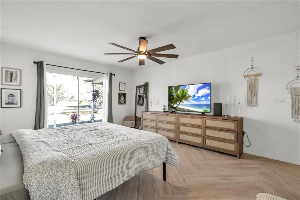 320 Tandil Street Punta Gorda, FL 33983 - Photo 31 of 67 a bedroom with a bed and a flat screen tv
