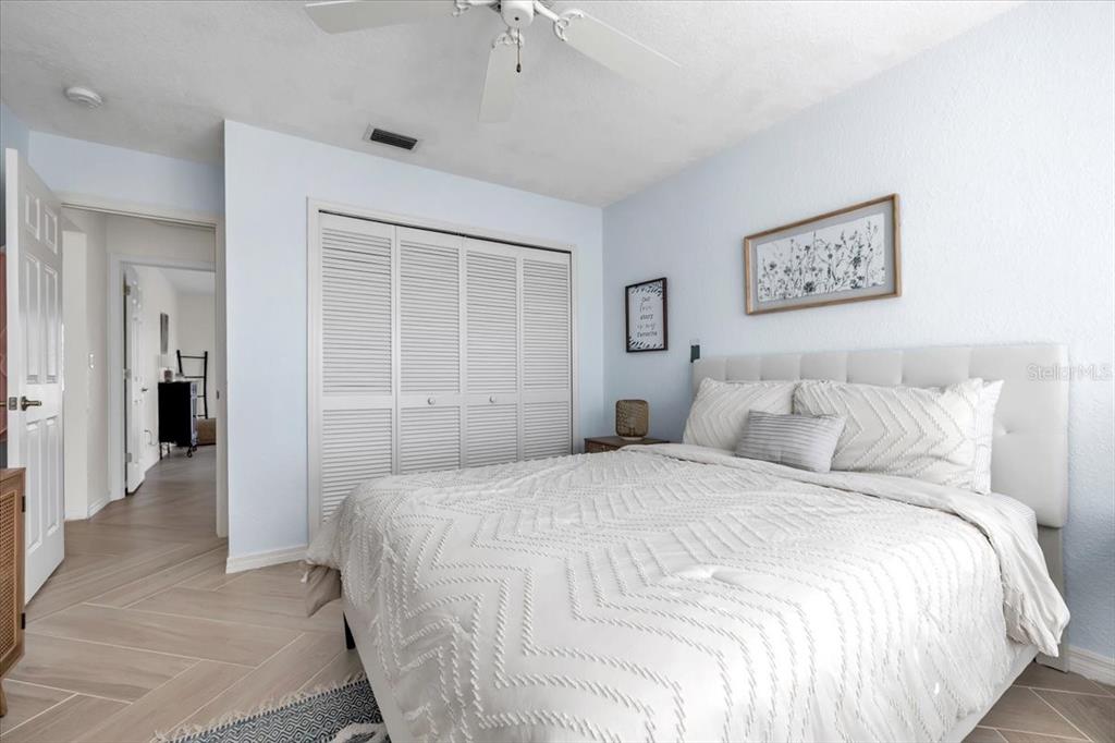 320 Tandil Street Punta Gorda, FL 33983 - Photo 40 of 67 a bedroom with a large bed and a chandelier