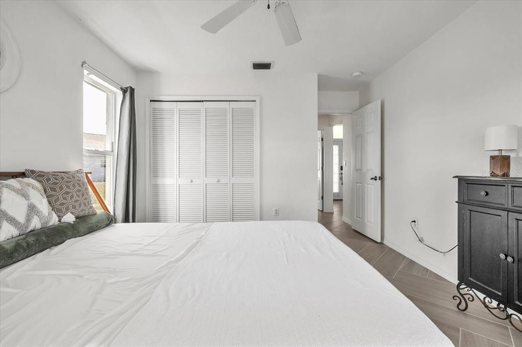 320 Tandil Street Punta Gorda, FL 33983 - Photo 46 of 67 a spacious bedroom with a bed and a chandelier