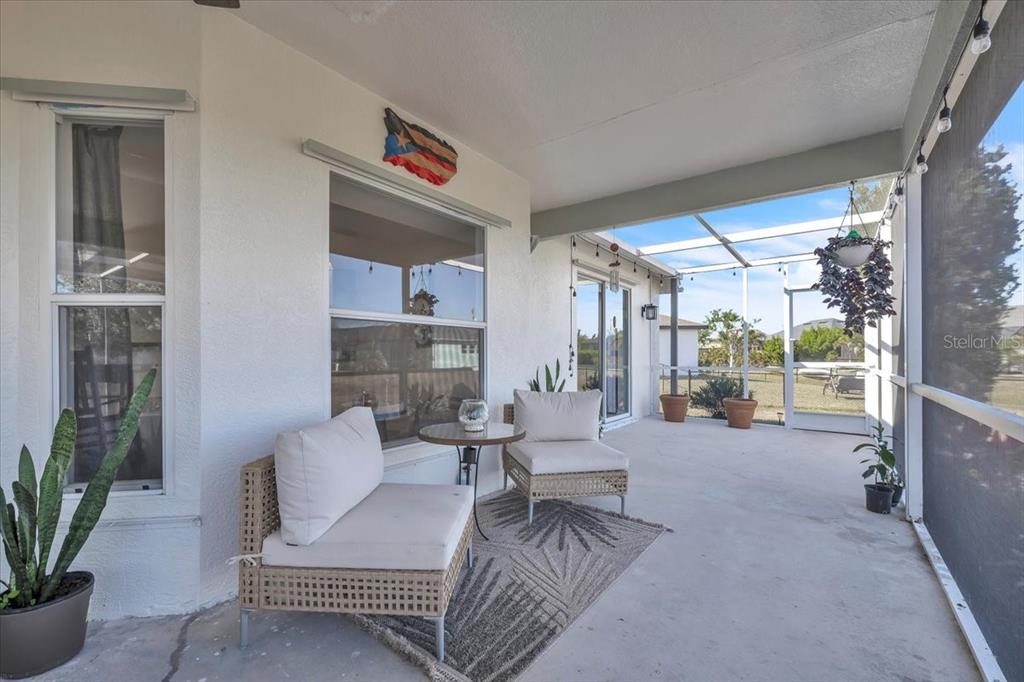320 Tandil Street Punta Gorda, FL 33983 - Photo 54 of 67 a living room with furniture and a floor to ceiling window