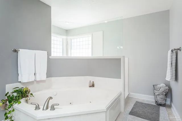a bathroom with a tub and a window
