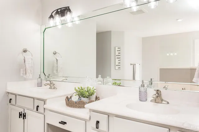 a bathroom with a sink vanity and a mirror